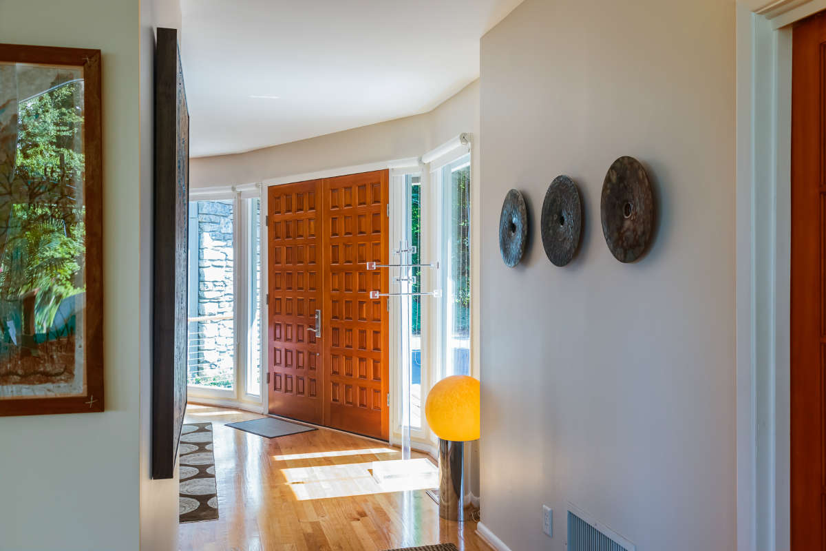 Foyer Design With Wood Paneled Door